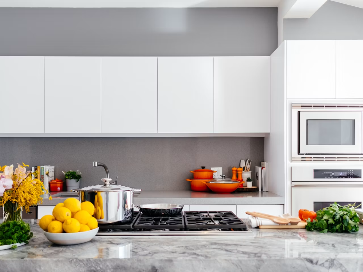 Renovated kitchen with full-height white cabinetry and stone countertops